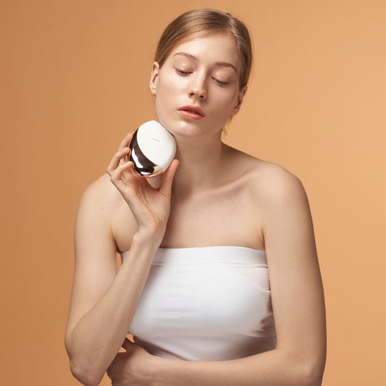 Woman holding AAlok FITSERA against a beige background