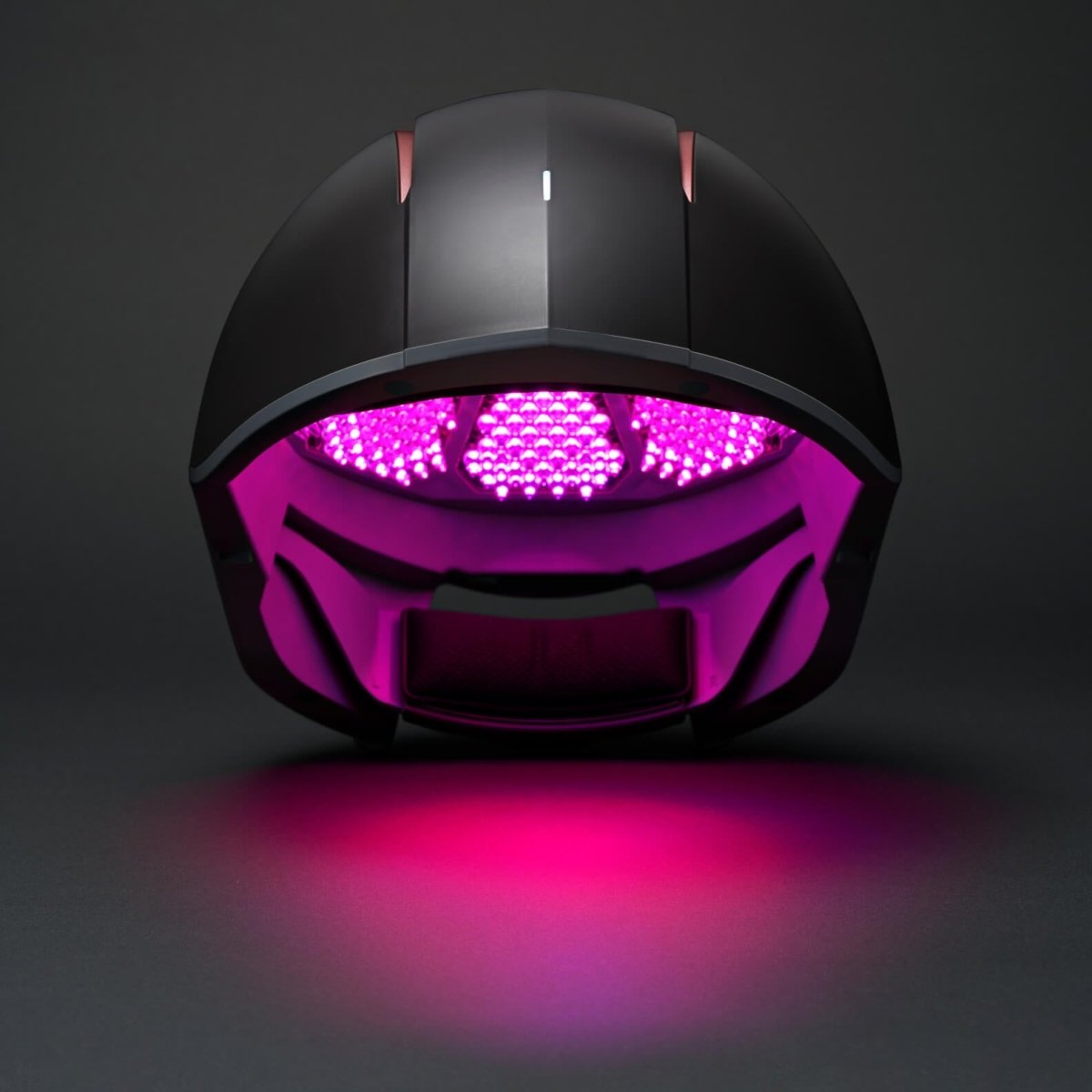 Aalok Hairbud with purple LED lights on a dark background