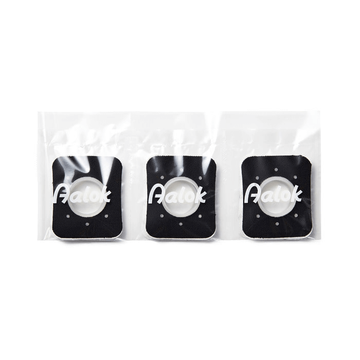 Three black patches with 'Aalok' branding in clear packaging on a white background