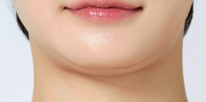 Close-up of a person's lips with a neutral background